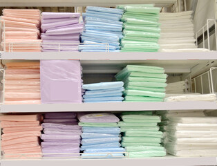 Selling sheets of different colors and sizes in a textile store