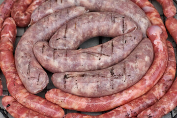 Sausages on the barbecue grill, raw sausages