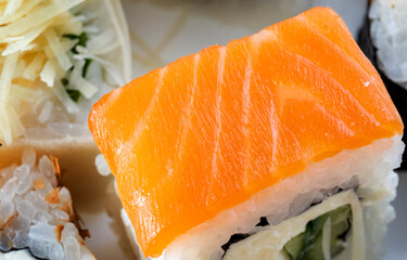 Roll Philadelphia with salmon, cucumber and cream cheese, beautiful fish texture.