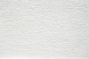 White facade wall texture rough stucco close up.