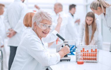 female scientist sitting at a Desk in the laboratory.