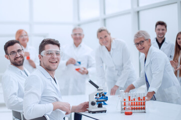 young scientist and his colleagues work in the laboratory.