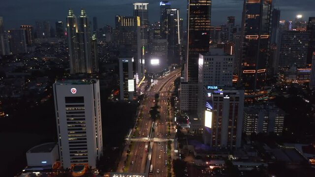 Aerial shot of traffic on the multi lane highway through the modern city center in the night in Jakarta, Indonesia