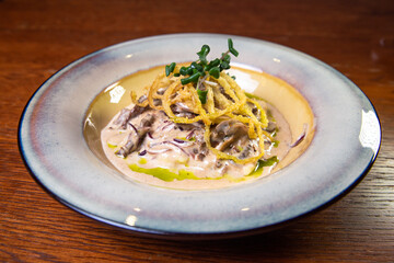 potato julienne Pie with meat in sauce on a plate