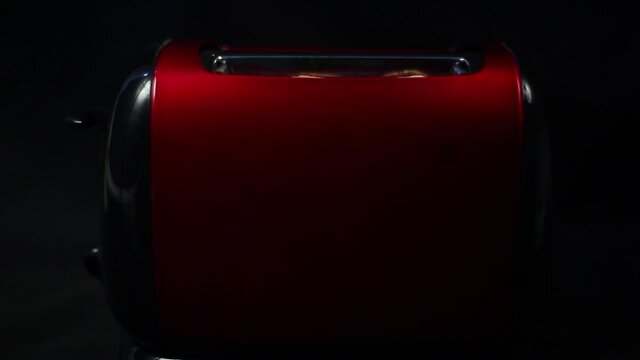 Roasted bread jump out from red toaster.4K