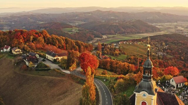 Aerial view of Austrian vilage Kitzeck im Sausal on vineyard. Shoot of Church on the top of grape hill. Travel destination.