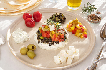 Greek salad on a plate with ingredients around it