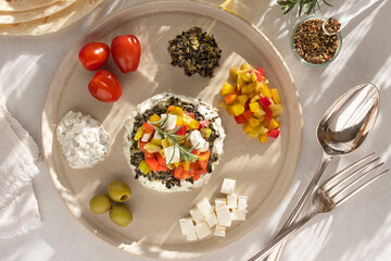 Greek salad on a plate with ingredients around it