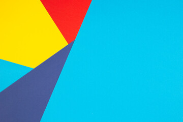 Color papers geometry flat composition background with yellow, red and blue tones
