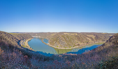 Panoramic image of the Loreley rock on the Rhine river taken from the opposite side of the Rhine under blue sky and sunshine