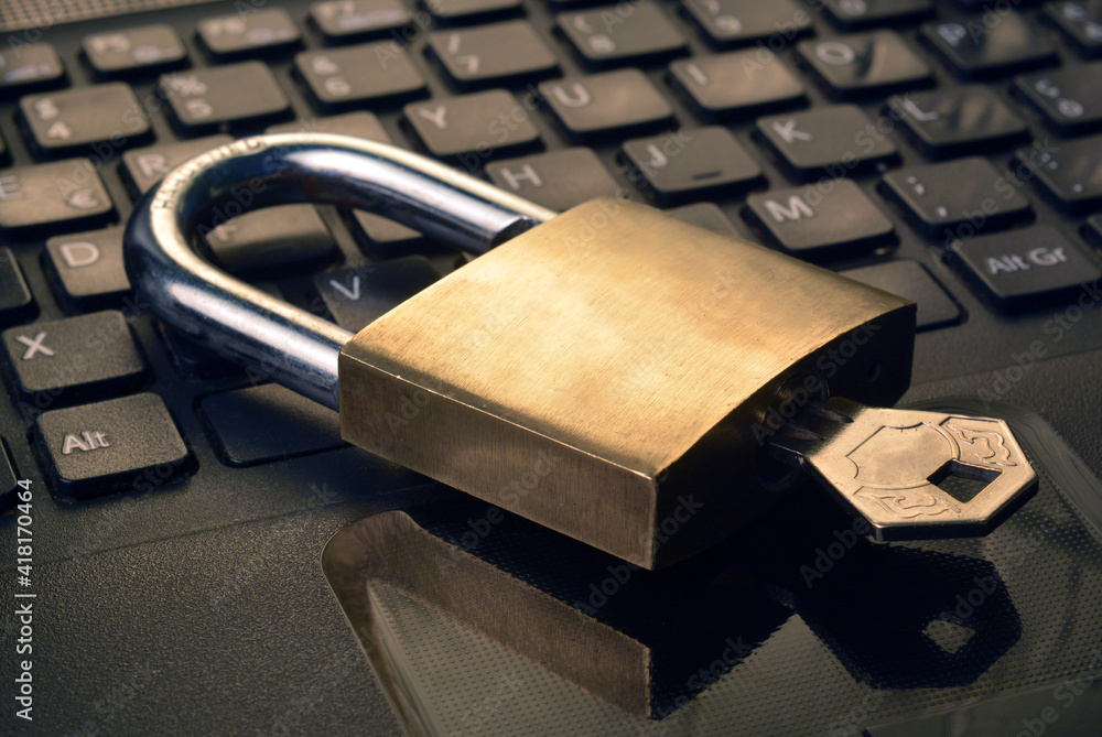 Poster detail of a metallic security padlock above a computer keyboard,