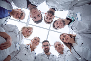 Fototapeta na wymiar close up. group of doctors standing in a circle and looking at you