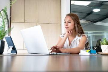 Woman working in a office in front of the computer.