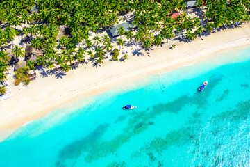 Saona, Dominican Republic. Vacation background. Aerial drone view of beautiful caribbean tropical island beach with palms and boats