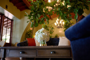 Bouquet of white flowers in a vase on the coffee table in the room