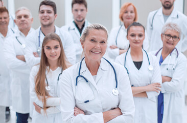 adult female doctor and a group of her colleagues standing together.