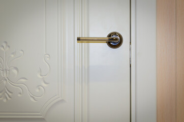 White door to the room in the evening light.