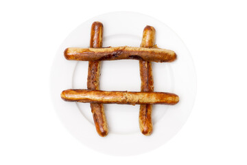 Hash symbol made of grilled german sausages on a white plate isolated on white