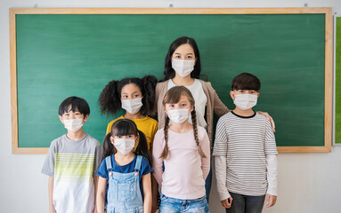 Fototapeta na wymiar Portrait of group of international asian caucasian students and teacher wearing face mask, self protection from corona virus pandemic. New normal children lifestyle, back to school concept