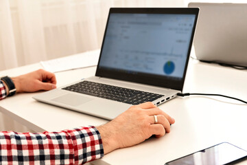 Closeup of business man's hand using computer mouse. Selective focus.