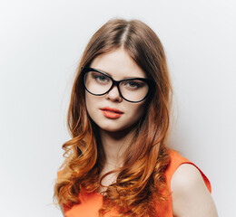 Fototapeta premium pretty woman in orange sundress and glasses makeup portrait
