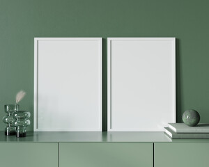 Mockup with two white frames standing on a chest of drawers a…