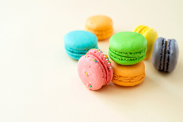 Tasty macarons on color background