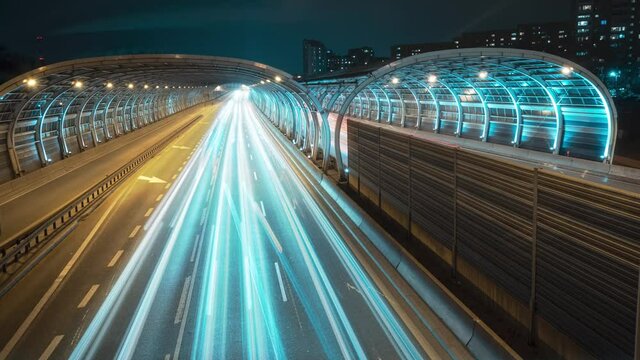 Infinite Timelapse Of A Busy Highway In The City Of Warsaw In Poland. Neon And Futuristic Aesthetics In Video With Invisible Loop, Long Exposure Banner Background. 