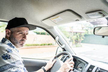 Man looking to the side while driving car