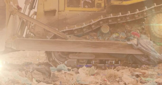 Animation of glowing light over bulldozer in waste disposal site