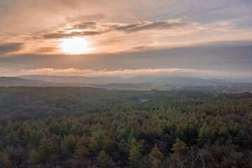 Beautiful sunset overt the forest from drone view