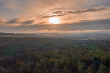 Beautiful sunset overt the forest from drone view