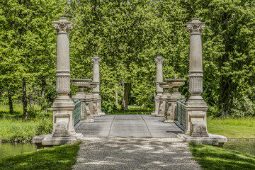 Fototapeta na wymiar Gorgeous ancient Bridge in English Garden (Jardin Anglais, 1817). Famous Chateau de Chantilly (Chantilly Castle, 1560) - historic chateau, town of Chantilly, Oise, Picardie, France.