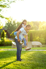 Young romantic couple have fun enjoy each other in green summer park