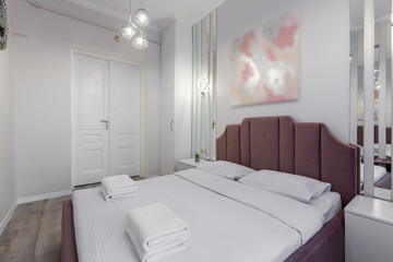 Bedroom interior, modern style, large bed, light colors, white, pink, beige