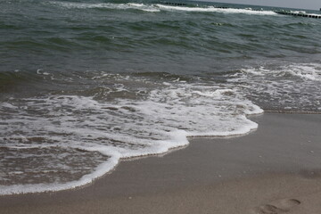 Welle am Sand