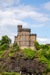 an old tower castle on a hillside