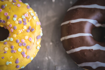 donuts yellow and chocolate Grey background
