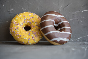 donuts yellow and chocolate Grey background