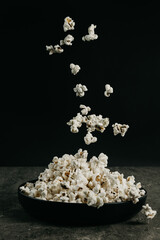 falling pop corn on black background