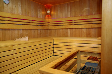 Finnish or dry sauna with oceanview or view of the sea inside male locker room of spa or wellness...