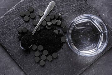 activated carbon on a dark stone background