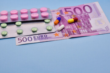 Original photograph of drugs on a blue background and 500 euro bills.