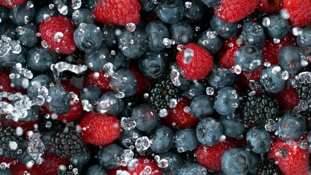 Super slow motion of berries with splashing water, top view. Filmed on high speed cinema camera, 1000 fps.