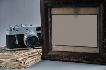 Old vintage objects - camera, book and empty photo frame