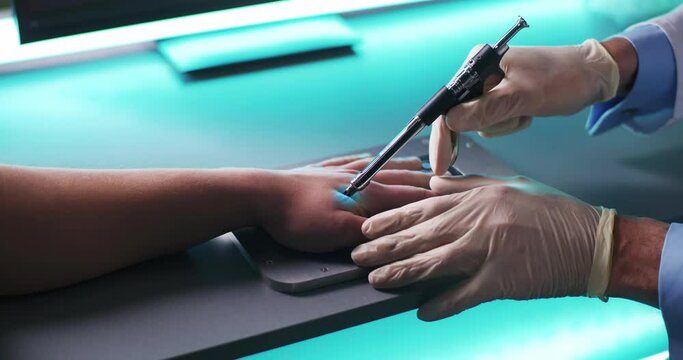 Crop doctor injecting RFID chip into hand of patient