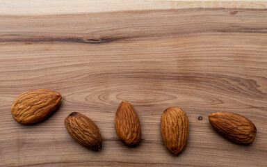Almonds taken in close-up on a wooden background. Healthy eating and vegetarianism. The concept of healthy lifestyle.