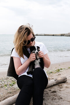 woman relaxed with her dog near sea