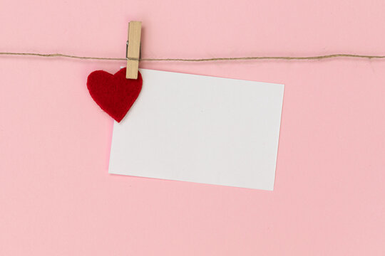 White piece of paper pinned to rope with clothespin.