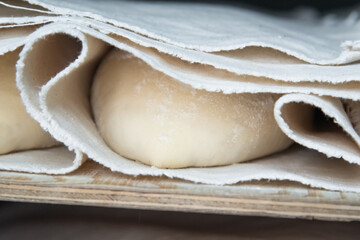 Baker making bread , man hands , kneading a dough , cooking coat.The concept of small bakeries, craft traditional bread
